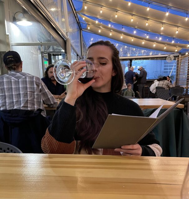 Me, Juls, drinking wine and looking at a menu