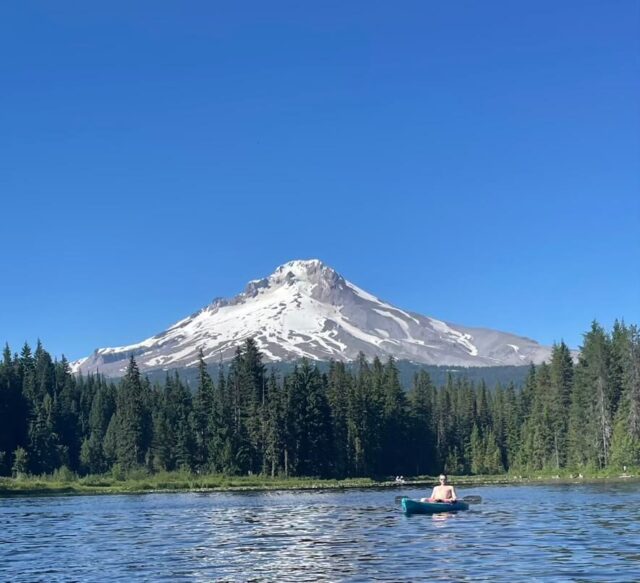 My husband kayaking at Trillium Lake with Mount Hood in the background
